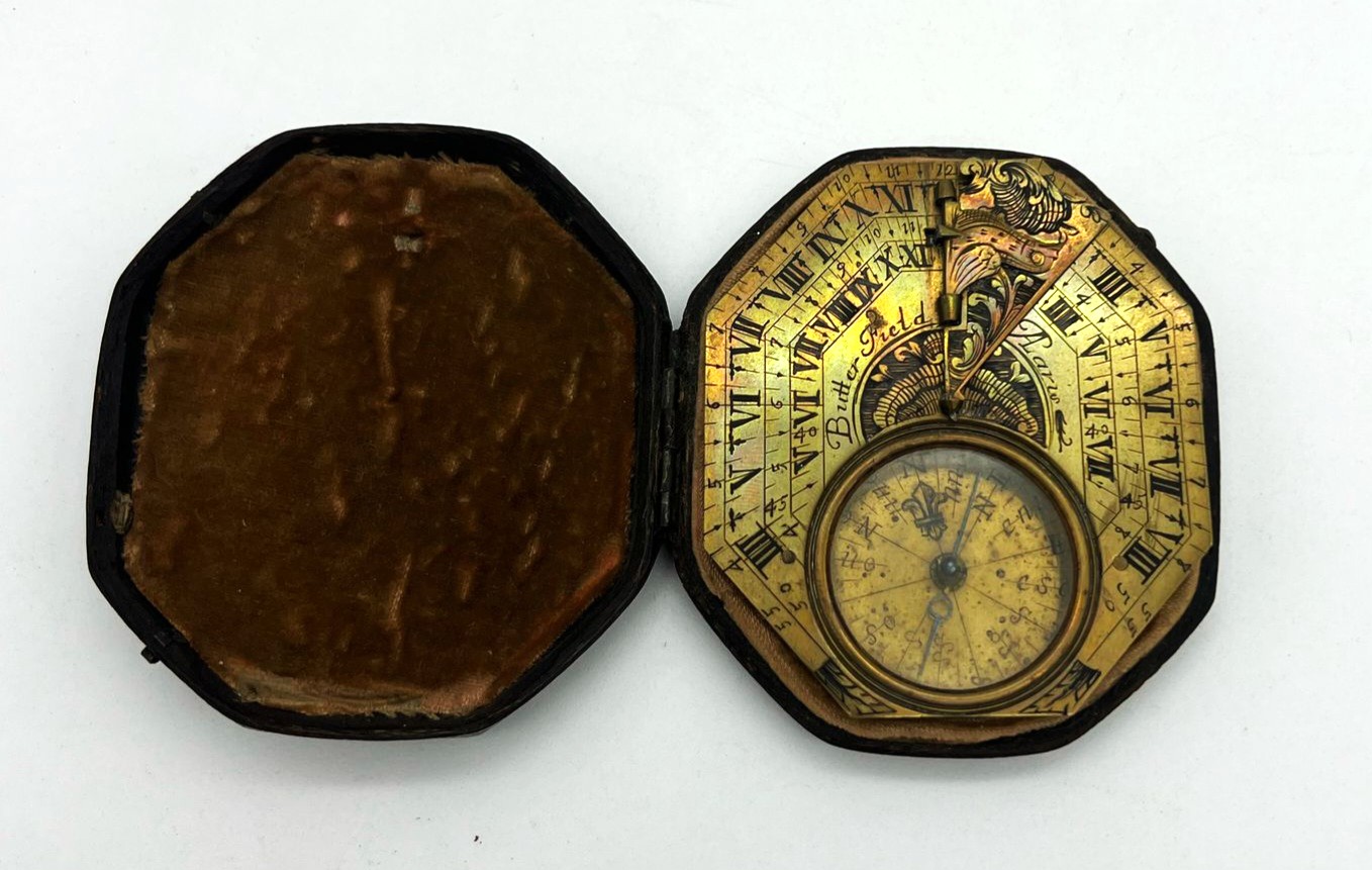 A complete and cased brass horizontal sundial by Butterfield with shell decoration, circa 1710